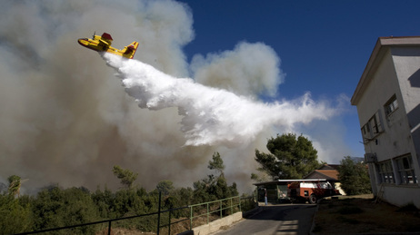A firefighting plane flies over Israel.