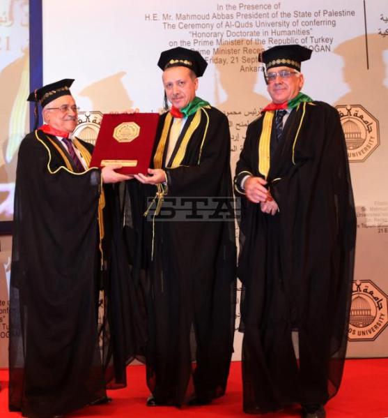 Turkish Prime Minister Tayyip Erdogan (C) receives a Honorary Doctorate Degree of Palastine's Al-Quds University from Palestinian President Mahmoud Abbas in Ankara, Turkey 21 September 2012. EPAUMIT BEKTASREUTERS POOL