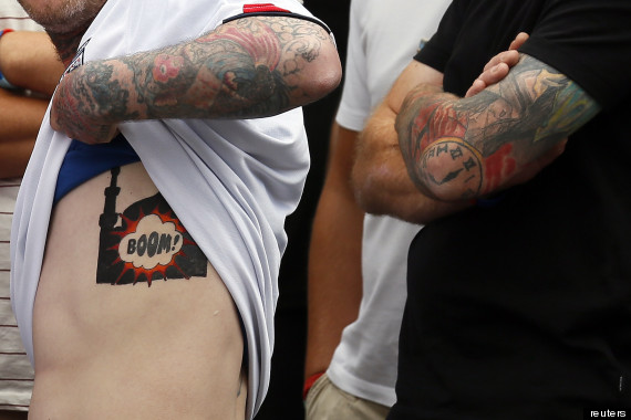 A supporter of the right-wing and anti-Islamist English Defence League (EDL) shows his stencil of an exploding mosque during a protest in Birmingham
