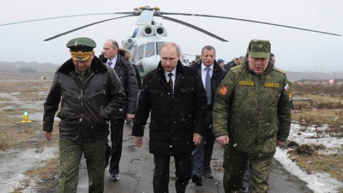 Russia's President Putin, accompanied by Russian Defence Minister Shoigu, walks to watch military exercises upon his arrival at Kirillovsky firing ground in Leningrad region