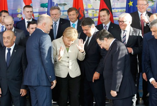 German Chancellor Merkel reacts as she poses for a group picture at the "West Balkan Conference" in Berlin