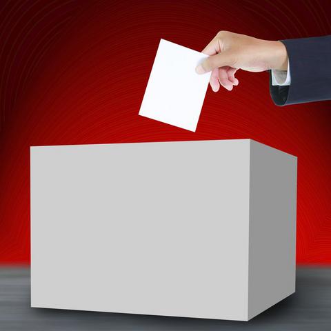 Hand with ballot and box