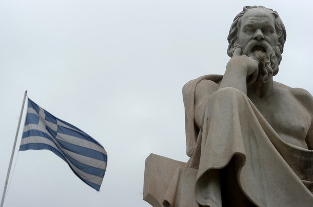 A Greek flag flies next to a statue of ancient Greek philosopher Socrates in the center of Athens on 23 May, 2012.  International Monetary Fund (IMF) chief Christine Lagarde warned on May 23 of the risk of "contamination" if Greece quits the euro and said the eurozone might therefore see the value of paying more to keep Greece in. AFP PHOTO / ARIS MESSINIS        (Photo credit should read ARIS MESSINIS/AFP/GettyImages)